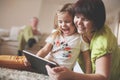 Grandmother and granddaughter using tablet. Royalty Free Stock Photo