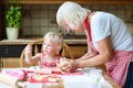 Grandmother and granddaughter making cookies together Royalty Free Stock Photo