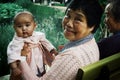 Grandmother with granddaughter in a park with friends