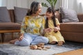 Grandmother and granddaughter play games. Blockwood Puzzle To develop skills for granddaughter and as a holiday activity