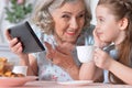 Grandmother with granddaughter playing in a tablet computer Royalty Free Stock Photo