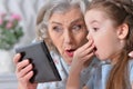 Grandmother with granddaughter playing in a tablet computer Royalty Free Stock Photo