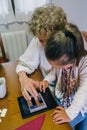 Grandmother and granddaughter playing with tablet Royalty Free Stock Photo