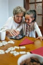 Grandmother and granddaughter playing with tablet Royalty Free Stock Photo