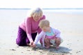 Grandmother and granddaughter playing together on the beach Royalty Free Stock Photo