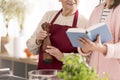 Grandmother and granddaughter reading a recipe book Royalty Free Stock Photo