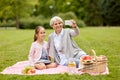 Grandmother and granddaughter take selfie at park Royalty Free Stock Photo