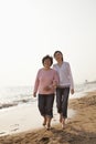 Grandmother and Granddaughter Taking a Walk by the Beach, Smiling Royalty Free Stock Photo