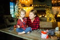 Grandmother and granddaughter together meet Christmas morning in a hunting house decorated with garlands. Royalty Free Stock Photo