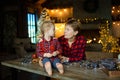 Grandmother and granddaughter together meet Christmas morning in a hunting house decorated with garlands. Royalty Free Stock Photo