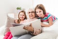 Grandmother with granddaughters looking family photo album Royalty Free Stock Photo