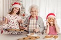 Grandmother with granddaughters baking cookies Royalty Free Stock Photo