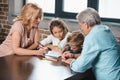 grandmother grandfather and grandchildren drawing together Royalty Free Stock Photo