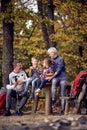 Grandmother, grandfather and grandchildren enjoying lovely moments in the forest