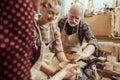 Grandmother and grandfather with granddaughter making pottery Royalty Free Stock Photo