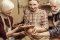 Grandmother and grandfather with granddaughter making pottery Royalty Free Stock Photo