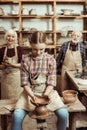 Grandmother and grandfather with granddaughter making pottery Royalty Free Stock Photo