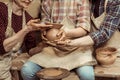 Grandmother and grandfather with granddaughter making pottery at workshop Royalty Free Stock Photo