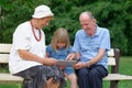 Grandmother, grandfather and granddaughter using tablet