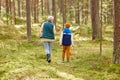 grandmother and grandson with baskets in forest