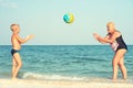 Grandmother with grandson on beach playing ball. Royalty Free Stock Photo