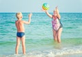 Grandmother with grandson on beach playing ball. Royalty Free Stock Photo