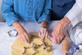 Grandmother with grandson cooking, kneading dough, baking in the kitchen