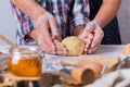 Grandmother with grandson cooking, kneading dough, baking in the kitchen