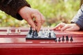 Grandmother hand makes move on chessboard in game in park Royalty Free Stock Photo