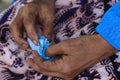 Grandmother hands holding handkerchief on lap closeup. Senior mother in deep feeling of sadness, loneliness and restless.