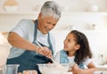 Grandmother, happy or child baking in kitchen as a happy family with young girl learning cookies recipe. Mixing cake Royalty Free Stock Photo