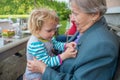 Grandmother having her grandaughter in lap and talking. Royalty Free Stock Photo