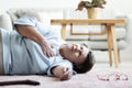 Grandmother with heart attack lying on the floor alone Royalty Free Stock Photo