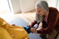 Grandmother helping granddaughter to get ready to leave home for school. Royalty Free Stock Photo