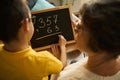 Grandmother helping grandson study math at home Royalty Free Stock Photo