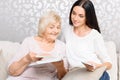 Grandmother with her daughter holding book Royalty Free Stock Photo