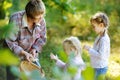 Grandmother and her girls picking mushrooms Royalty Free Stock Photo