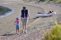 Grandmother and her grandchild walks on the beach