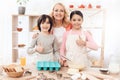 Grandmother with her grandchildren cooks pastries in kitchen. Baking cookies. Royalty Free Stock Photo