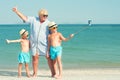 Grandmother with her grandchildren are resting on the sea, they are make a selfie on the beach.