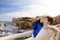 Grandmother and her little grandchild looking on yachts and boats in port of Monaco in winter day