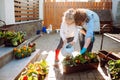 Grandmother with her little granddaughter gardening in a backyard. Different generation. Grandmawith and granddaughter planting Royalty Free Stock Photo