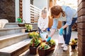 Grandmother with her little granddaughter gardening in a backyard. Different generation. Grandmawith and granddaughter planting