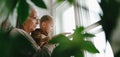 Grandmother with her little grandson looking out of the window. Royalty Free Stock Photo