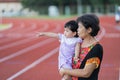 Grandmother holding baby exercise at the sport stadium Royalty Free Stock Photo