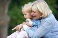 Grandmother holding baby girl and pointing Royalty Free Stock Photo