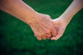 Grandmother holding grandchild hand in nature. National Grandparents Day, family concept. Two generations. The old woman Royalty Free Stock Photo