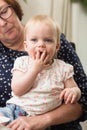 Grandmother holding her grandchild, happy family colorful Royalty Free Stock Photo