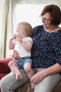 Grandmother holding her grandchild, happy family colorful Royalty Free Stock Photo