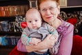 Grandmother holds a half-year-old grandson